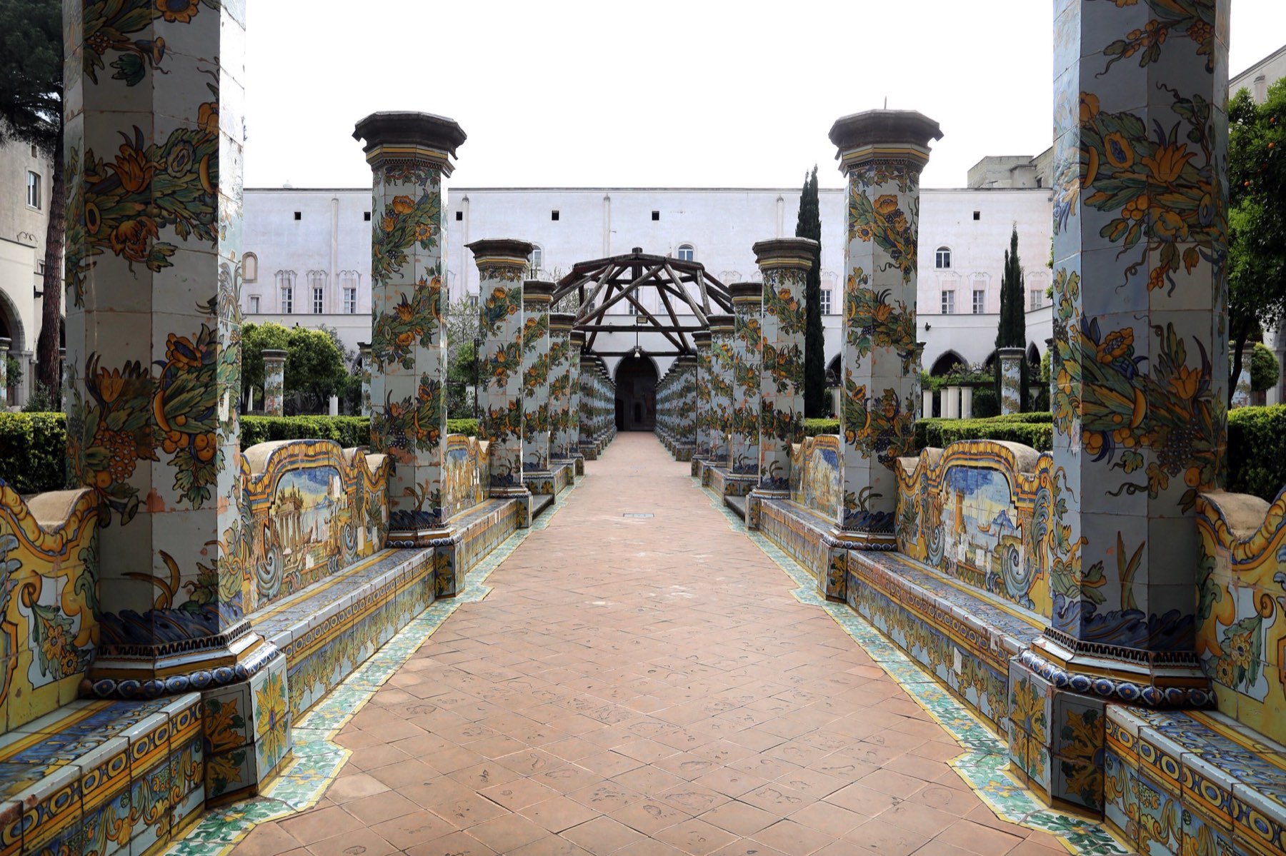 The majolica-tiled cloister of Santa Chiara, with painted columns and benches